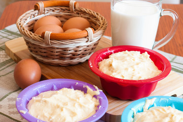 Dough for cakes in tins for baking