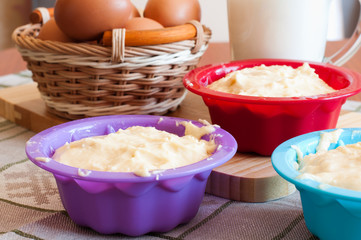 Dough for cakes in tins for baking
