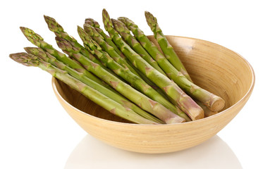 Fresh asparagus in wooden bowl isolated on white.