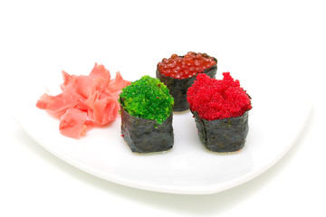 sushi with caviar and ginger on a white plate on a white backgro