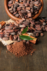 Cocoa beans in bowl, cocoa powder and spices