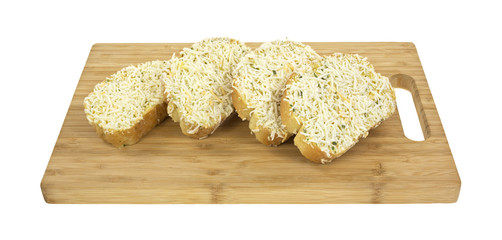 Frozen cheese bread on cutting board