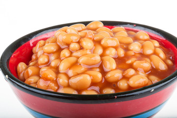Marinated haricot beans in tomato sauce with shallots on a plate