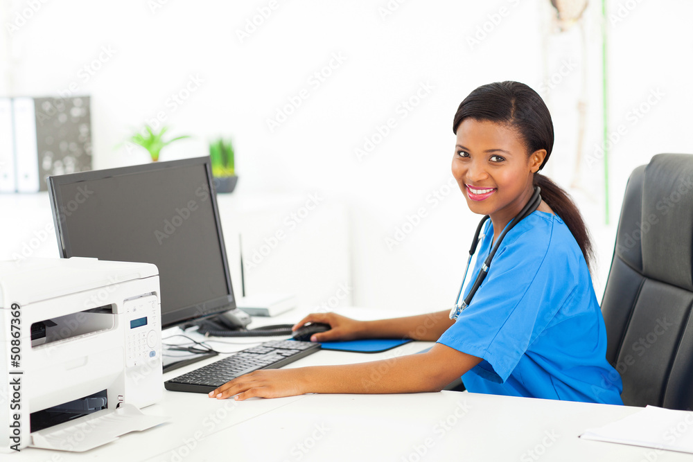 Wall mural afro american female doctor sitting in her office