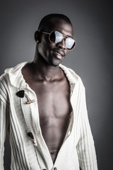 Confident young african man with sunglasses close up portrait.