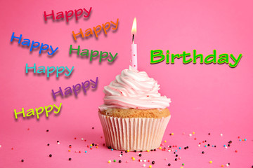 tasty birthday cupcake with candle, on pink background