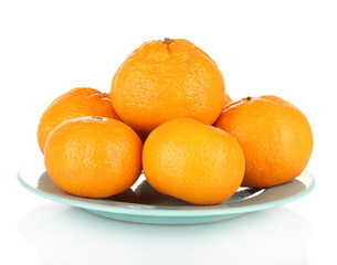 Tasty mandarines  on color plate isolated on white