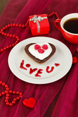 Chocolate cookie in form of heart with cup of coffee
