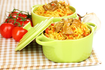 Delicious pilaf with tomato on table close up