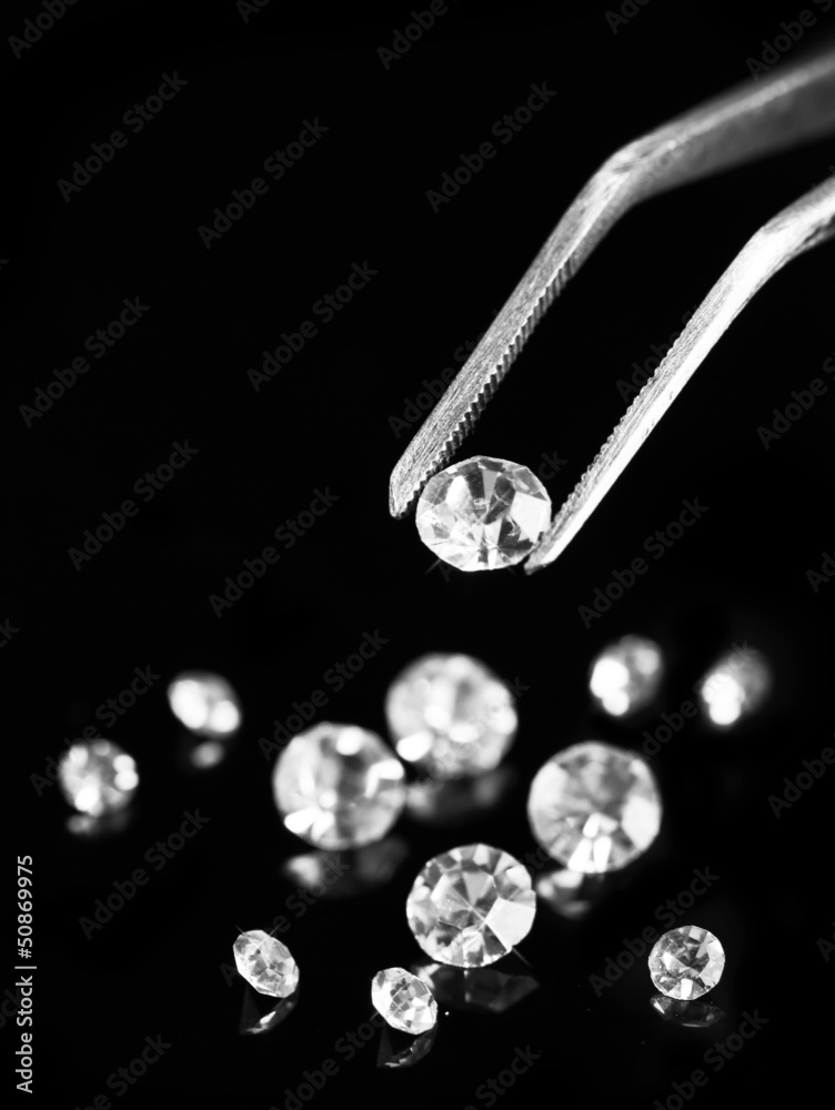 Canvas Prints beautiful shining crystal (diamond) in the tweezers,