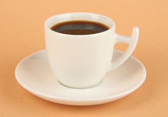 Cup of strong coffee on beige background