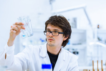 Young male researcher carrying out scientific research in a lab