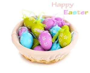 Colorful easter eggs in basket isolated on white