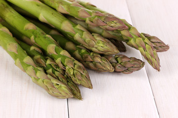 Fresh asparagus on white wooden table background