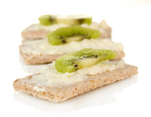Crispbread with cheese and kiwi, isolated on white