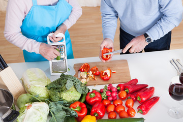 Senior Couple Cutting Vegetables