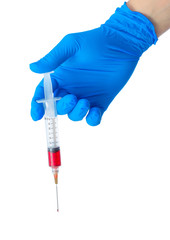 Hand holding syringe filled with red liquid.