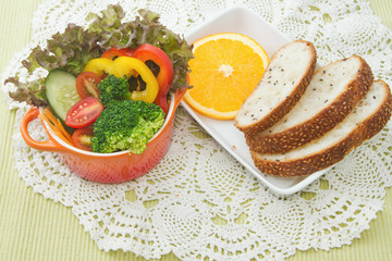 fresh vegetable salad bowl with whole wheat bread
