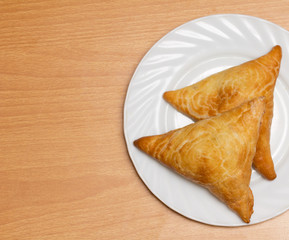 Uzbek samosa on a wooden background