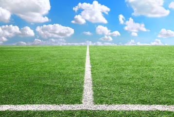 Football and soccer field grass stadium Blue sky background