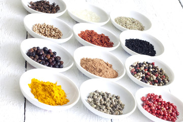 Spices and dried vegetables on vintage white planks closeup