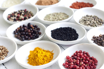 Spices and dried vegetables on vintage white planks closeup