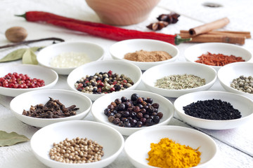 Spices and dried vegetables on vintage white planks closeup