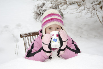 Girl with hot drink in the snow