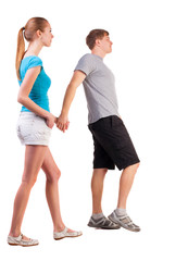 Back view of going young couple