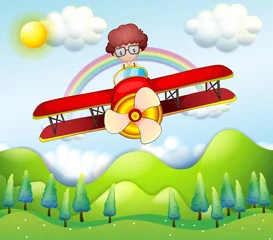 Poster Een jongen die in een rood vliegtuig rijdt © GraphicsRF