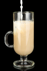 Cold coffee with ice in glass isolated on black