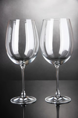 Empty wine glasses arranged on grey background
