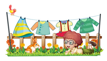 A boy and a bunny in a garden with hanging clothes
