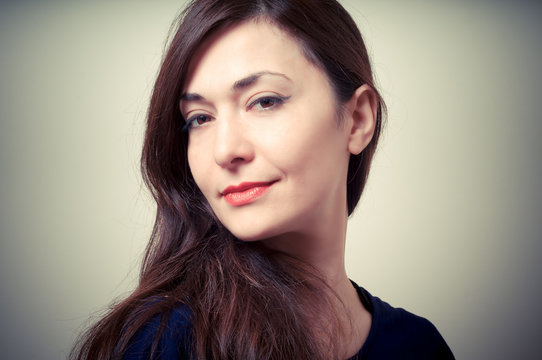 portrait of beautiful girl with long hair and blue sweater