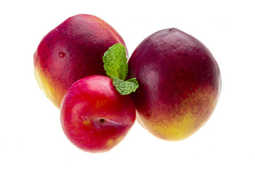 Ripe bright peaches, plum and mint