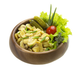 Marinated mushrooms in white saucer isolated on white