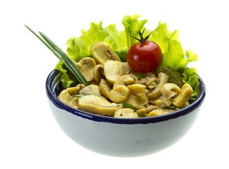 Marinated mushrooms in white saucer isolated on white