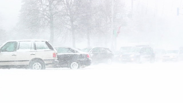 Busy traffic on country road at night in heavy snowstorm