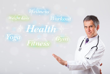 Clinical doctor pointing to health and fitness collection of wor