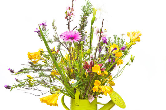 Bunch of fresh cut field flowers in a vintage green watering can