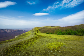Summer landscape in mountains and the dark blue sky with clouds