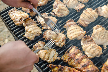 Preparing Pork Stakes On Barbecue