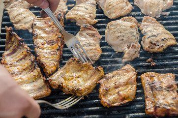 Preparing Pork Stakes On Barbecue