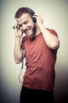 vintage portrait of fashion smiling guy with headphones