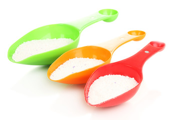 Washing powder in measuring cup isolated on white