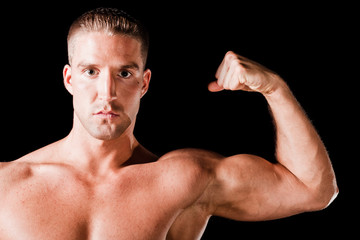 Muscular man isolated on black background