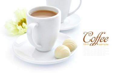 Cup of coffee with candies on white background