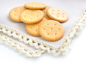 Crackers on beige linen napkin on a white background