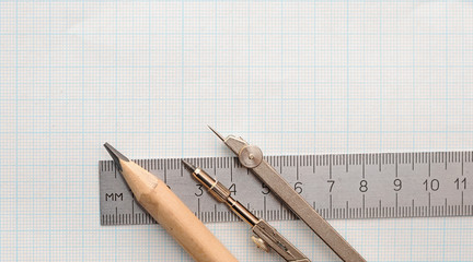 Still life photo of engineering graph paper with pencil, compass