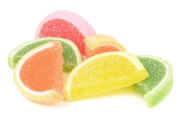 Fototapeta na wymiar A pile of sugar coated fruit jelly sweets on a white background